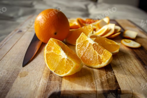 Preview: Oranges cut and sliced on a cutting board