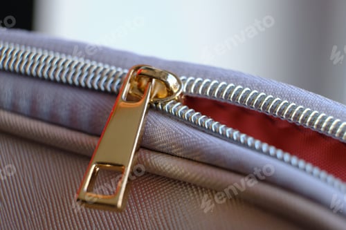 Preview: Selective focus, yellow metal zipper of a makeup bag or small purse macro pattern background