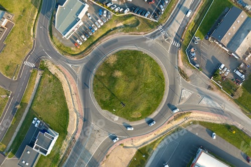 Preview: Aerial view of road roundabout intersection with moving heavy traffic.