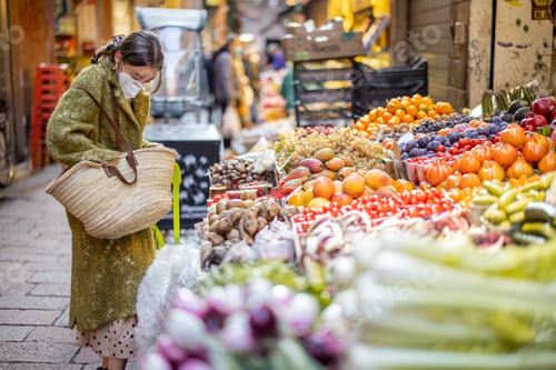 Preview: Woman buying food on the street market during pandemic
