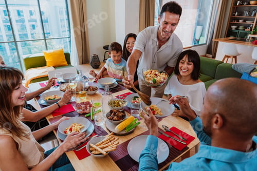 Preview: Family and friends reunion at home. Diverse family gathering enjoying dinner at home
