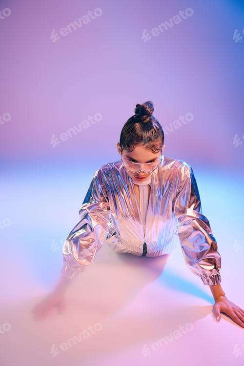 Preview: Stylish woman in holographic attire explores a vibrant futuristic space with confidence and grace