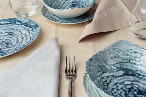 Preview: Details of a stylish table setting with textured ceramic dishes