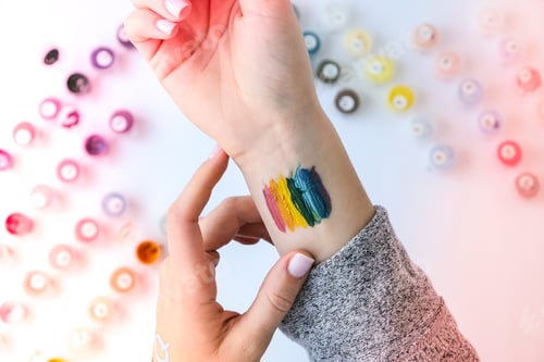 Preview: Rainbow LGBTQ flag painted on hand. Support for lgbt community. Honour of pride month. Connecting