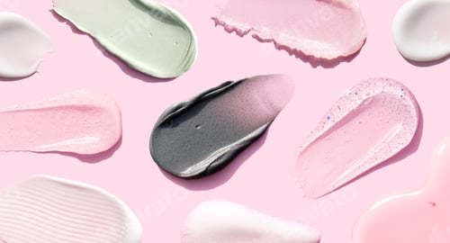Preview: creamy texture of cosmetic samples on pink background