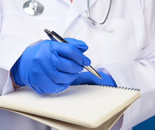 Preview: Medic woman in white coat, blue latex gloves holding an open notebook