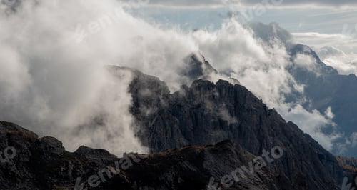 Preview: Rocky mountain peaks shrouded in mist and clouds. Tre cime dolomite Italy