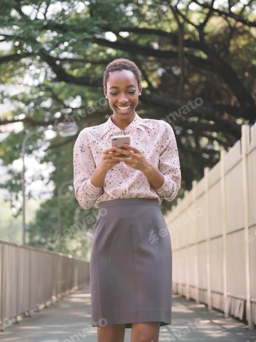 Preview: Woman texting outdoors