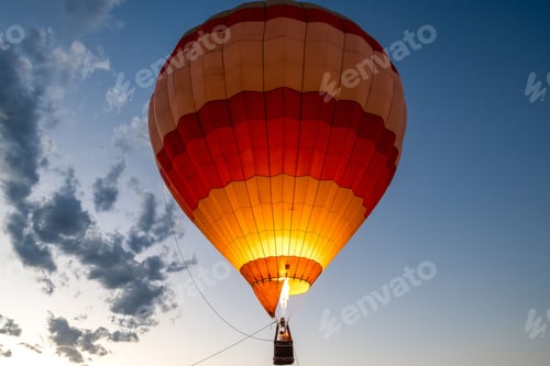 Preview: Aerial view of a colorful hot air balloon drifting through the sky