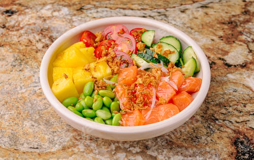 Preview: Fresh sushi bowl with salmon, pineapple, and vegetables on a marble surface