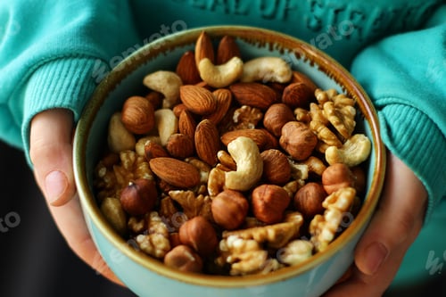 Preview: a plate of nuts. a nutritious and healthy snack. A mixture of walnuts, almonds, hazelnuts, cashews