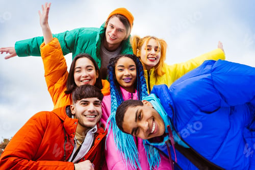 Preview: Multiracial group of young friends meeting outdoors in winter
