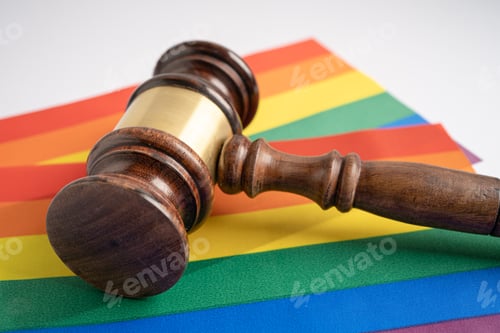 Preview: Gavel for judge lawyer on rainbow flag, symbol of LGBT pride month celebrate annual in June.