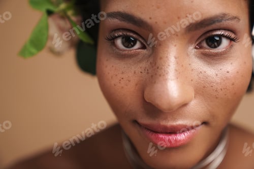 Preview: Portrait of half-naked african american woman with flowers in her hair