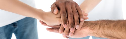 Preview: partial view of blurred multiethnic friends joining hands isolated on white, banner