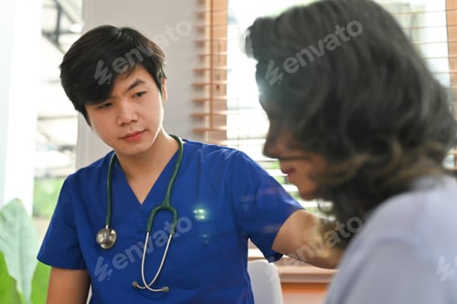 Vista previa: Caring doctor touching shoulder comforting upset senior patient after medical diagnosis at clinic.
