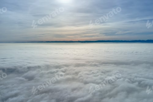 Preview: Aerial view from high altitude of earth covered with puffy rainy clouds forming before rainstorm