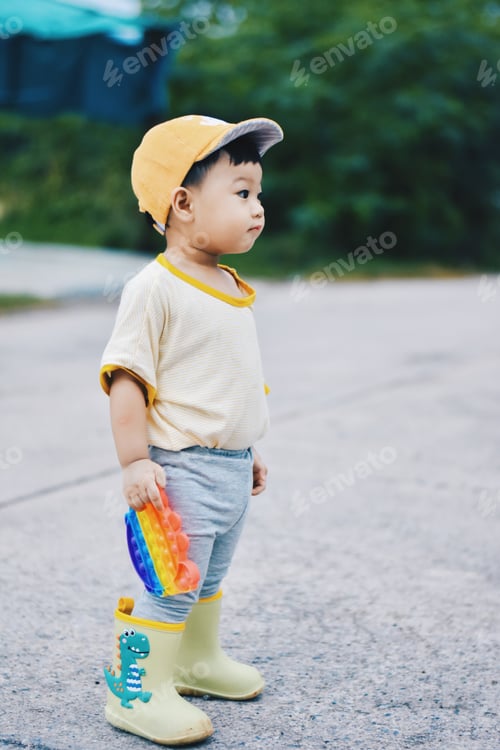 Preview: Little kid boy plays in pop it colorful toy