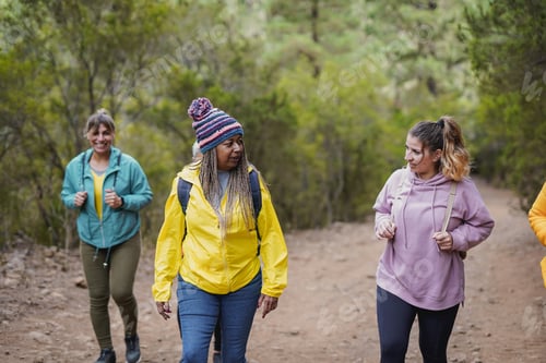 Preview: Happy group of multiracial women during hiking day in the mountains