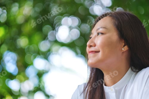 Preview: Portrait image of a young woman relaxing in the garden