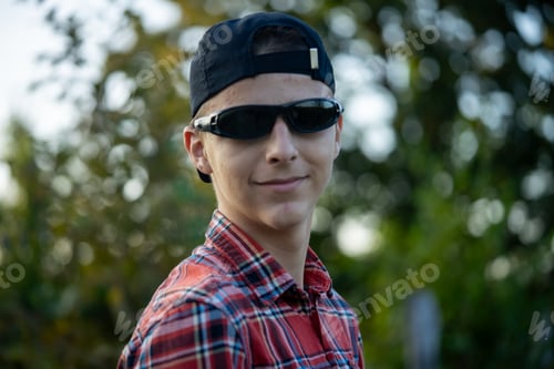 Preview: Teenage boy standing in rural area in front of his house