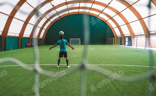 Preview: Cinematic image of a soccer freestyle player making tricks with the ball.