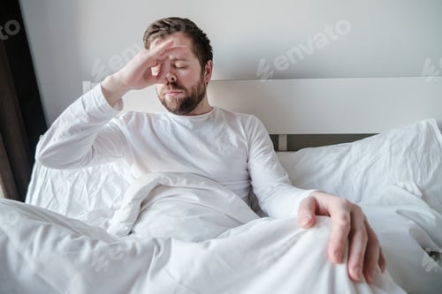 Preview: Man practices yoga exercise performs breathing technique with alternate nostrils of nadi shodhana