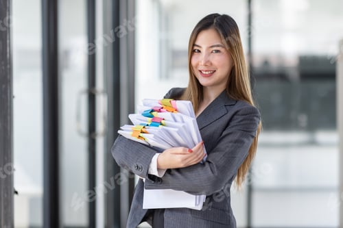 Preview: Young business Asian woman holding document file and looking at camera stand in workplace office, St