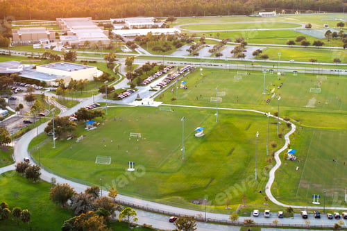 Preview: Public sports arena in North Port, Florida with school kids playing soccer game on grass