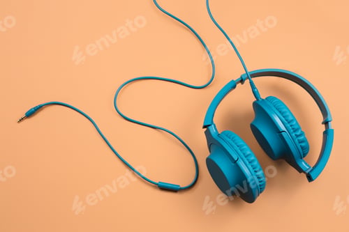 Preview: Photo of stylish modern blue cyan headphones over beige background