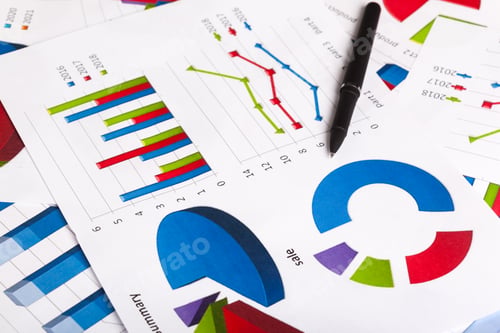 Business Charts with Pen Showing Analysis and Planning