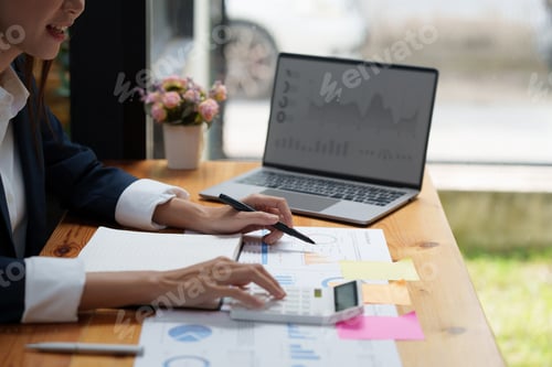 Preview: Close up Business woman hand using calculator to calculate the company's financial results and