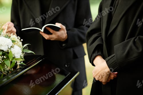 Preview: Outdoor funeral ceremony with priest reading prayer