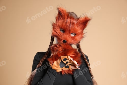 Preview: Quadrobics. Girl wearing fox mask and gloves on beige background