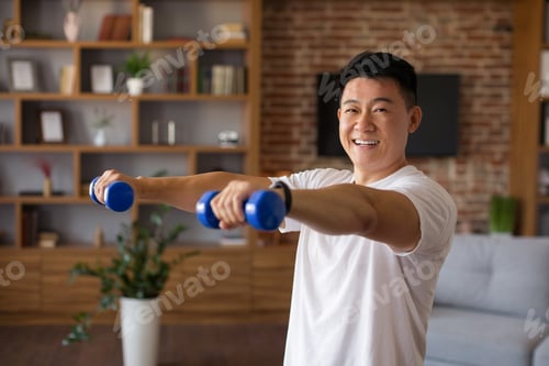 Preview: Home workout concept. Happy mature asian man doing domestic training with dumbbells, strengthening
