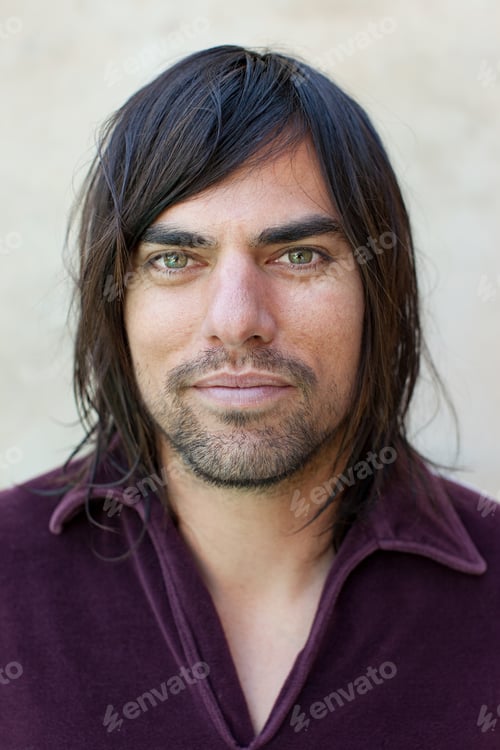 Preview: Portrait of mid adult man in purple shirt