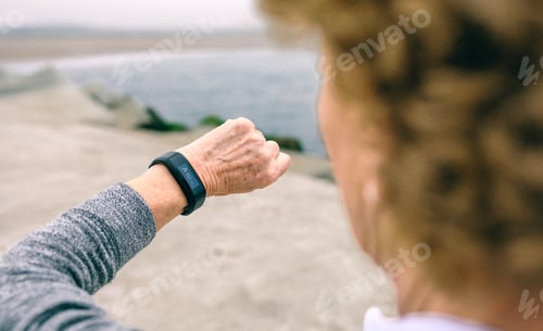 Preview: Senior woman looking smart watch