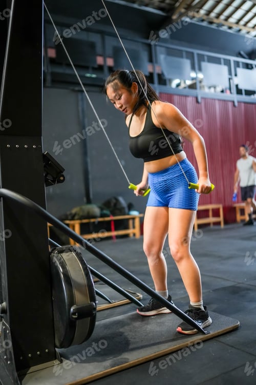 Preview: Woman working out in a gym with pulldown lat machine
