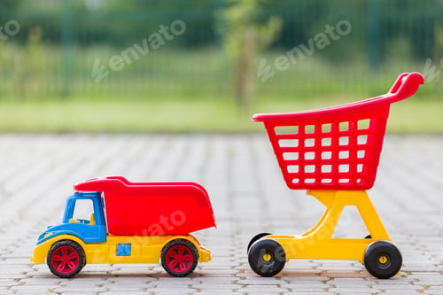 Preview: Bright plastic colorful toys for children outdoors on sunny summer day