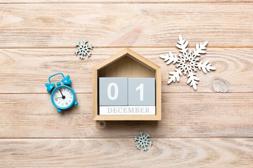 Preview: Christmas wood calendar with new year decorations, aganist colored background.