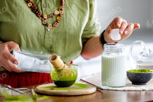 Preview: Woman Adding Ice To Matcha Latte