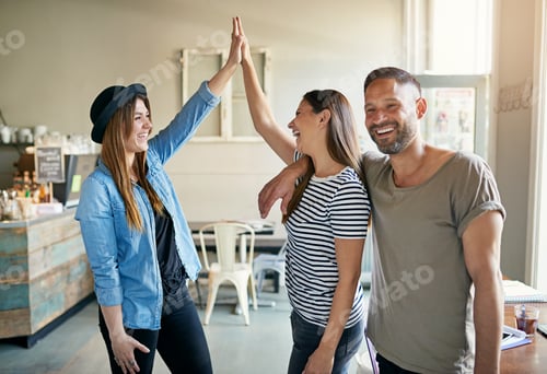 Preview: Two women putting up high fives with male friend