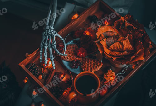 Preview: Wooden tray with breakfast and hand skeleton on the bedside table.