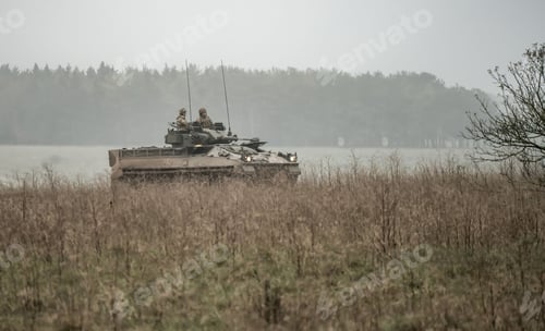 Preview: Military tank and soldiers with guns on a field