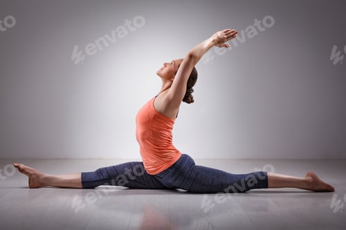 Preview: Sporty fit woman doing yoga asana Hanumanasana