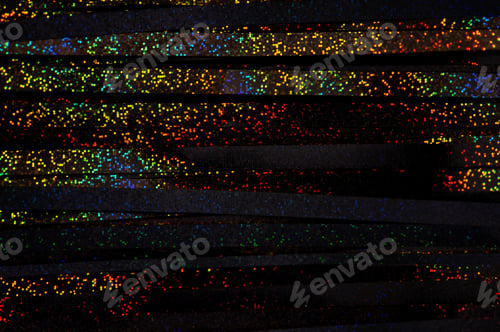 Preview: Colorful glowing rainbow drops and lights on black lined background.