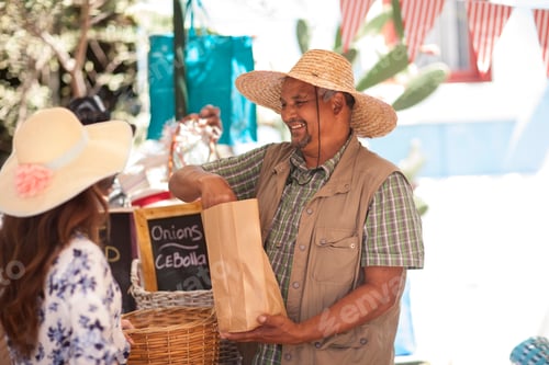 Preview: Market trader selling onions to tourist