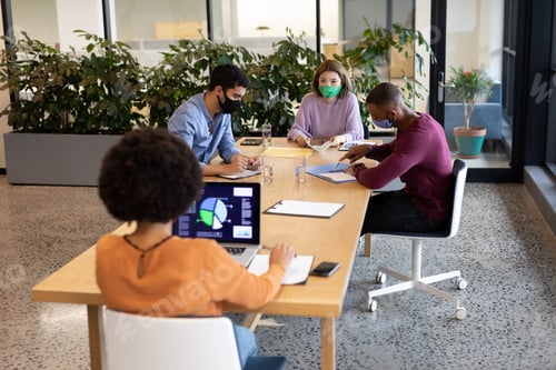 Preview: Diverse group of business people working in creative office