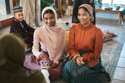 Preview: Shot of a group of muslim women relaxing together about to break their fast with dates