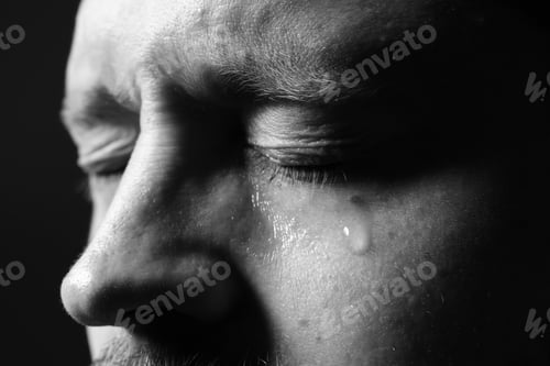 Preview: Sad man crying on dark background, closeup. Black and white effect